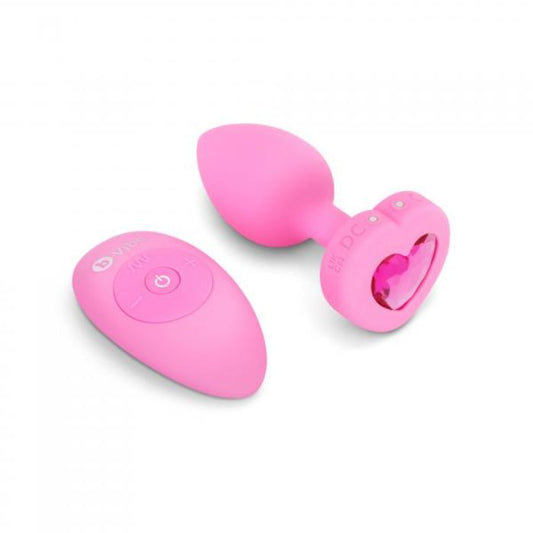 pink b-vibe butt plug with heart shaped base with a pink gem and a pink remote
