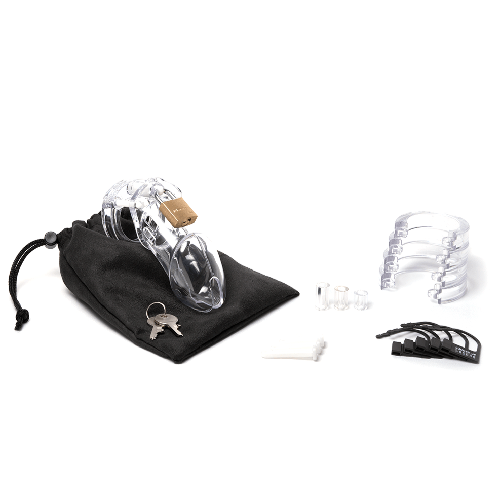Fully-assembled clear CB-6000 chastity cage on a black cotton storage pouch with 2 metal keys to left. 3 clear spacers, 3 white locking pins, 4 clear stacked U-rings and 5 black plastic locks lay displayed on right.