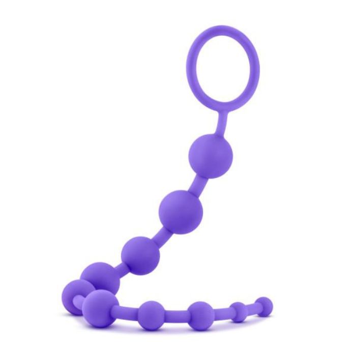 hanging purple string of Silicone Anal Beads with 10 beads starting from smallest to largest and increasing in size up to the removal ring