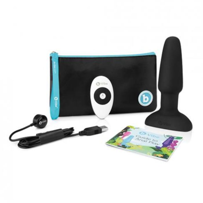 black plug, white remote with black accents, black storage bag with teal accents and white text, black USB charging cord, guide to anal play manual