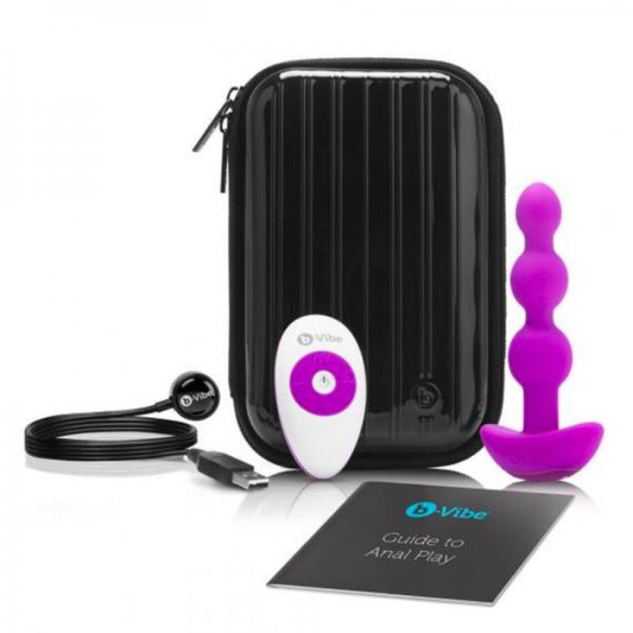 black hard body case with zipper around, magenta anal beads plug, white remote with magenta accents, black USB charging cord, black with teal b-vibe logo guide to anal play manual.
