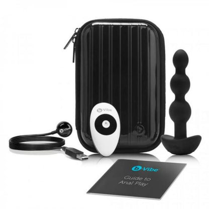 black hard body case with zipper around, black anal beads plug, white remote with black accents, black USB charging cord, black with teal b-vibe logo guide to anal play manual