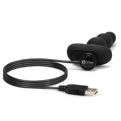 black anal beads style plug with large tapered end and magnetic USB charging cord attached.
