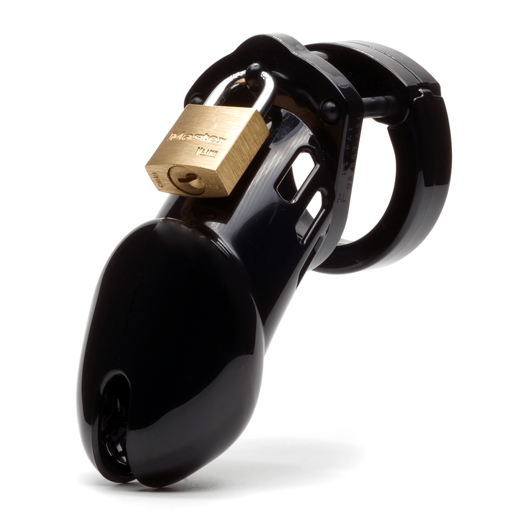 Front view, with tip angled to the left of a fully-assembled black CB-6000 penis chastity cage. Three black locking pins connect the base ring to the penis cage and a brass padlock is secured through the hole on the center locking pin.