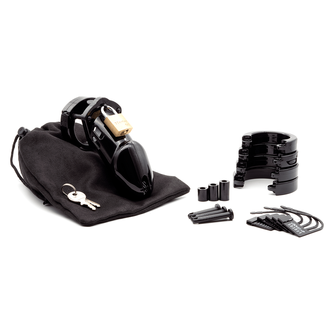 Fully-assembled black CB-6000 chastity cage on a black cotton storage pouch with 2 metal keys to left. 3 black spacers, 3 black locking pins, 4 black stacked U-rings and 5 black plastic locks lay displayed on right.