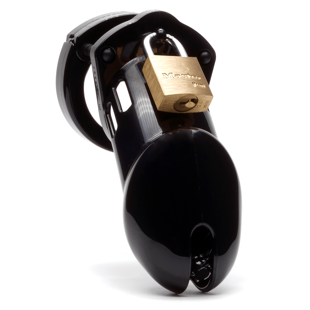 Front view, with tip angled to the right of a fully-assembled black CB-6000 penis chastity cage. Three black locking pins connect the base ring to the penis cage and a brass padlock is secured through the hole on the center locking pin.