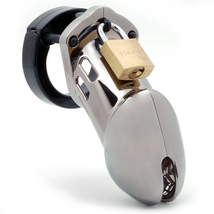 Front view, with tip angled to the right of a fully-assembled chrome finish and black CB-6000 penis chastity cage. Three black locking pins connect the black base ring to the chrome penis cage and a brass padlock is secured through the hole on the center locking pin.