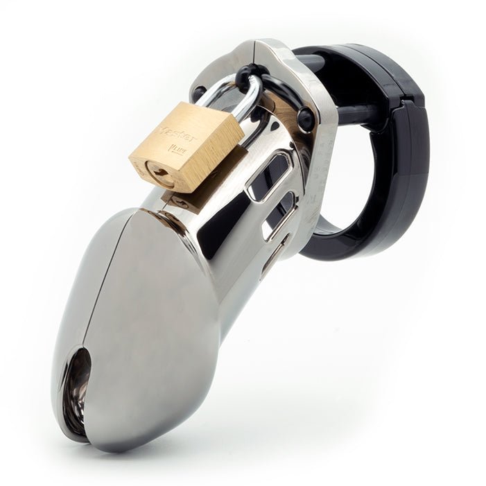 Front view, with tip angled to the left of a fully-assembled chrome finish and black CB-6000 penis chastity cage. Three black locking pins connect the black base ring to the chrome penis cage and a brass padlock is secured through the hole on the center locking pin.