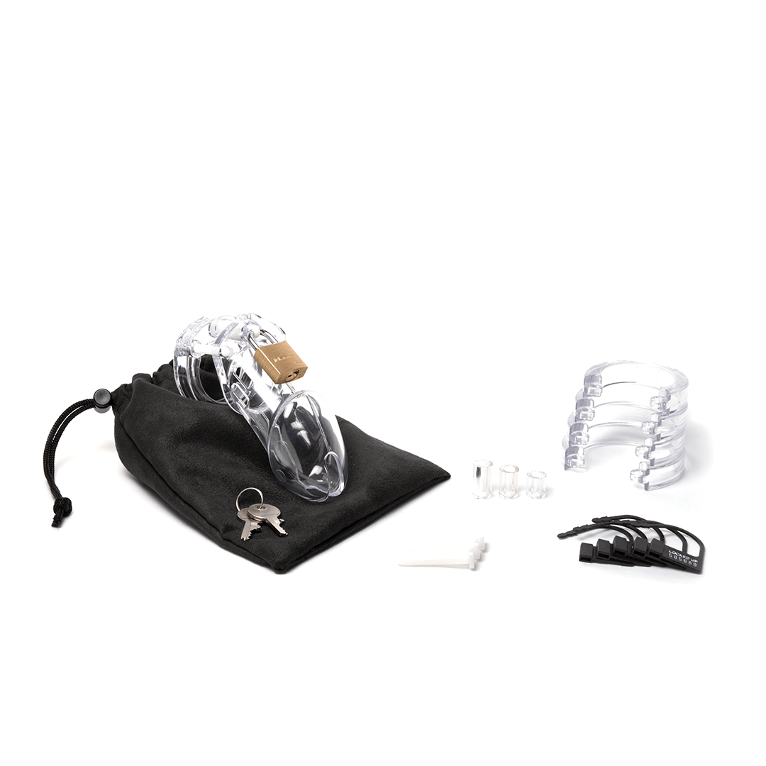 Fully-assembled clear CB-6000 chastity cage on a black cotton storage pouch with 2 metal keys to left. 3 clear spacers, 3 white locking pins, 4 clear stacked U-rings and 5 black plastic locks lay displayed on right.