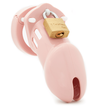 Front view, with tip angled to the right of a fully-assembled pale bubblegum pink CB-6000 penis chastity cage. Three white locking pins connect the base ring to the penis cage and a brass padlock is secured through the hole on the center locking pin.