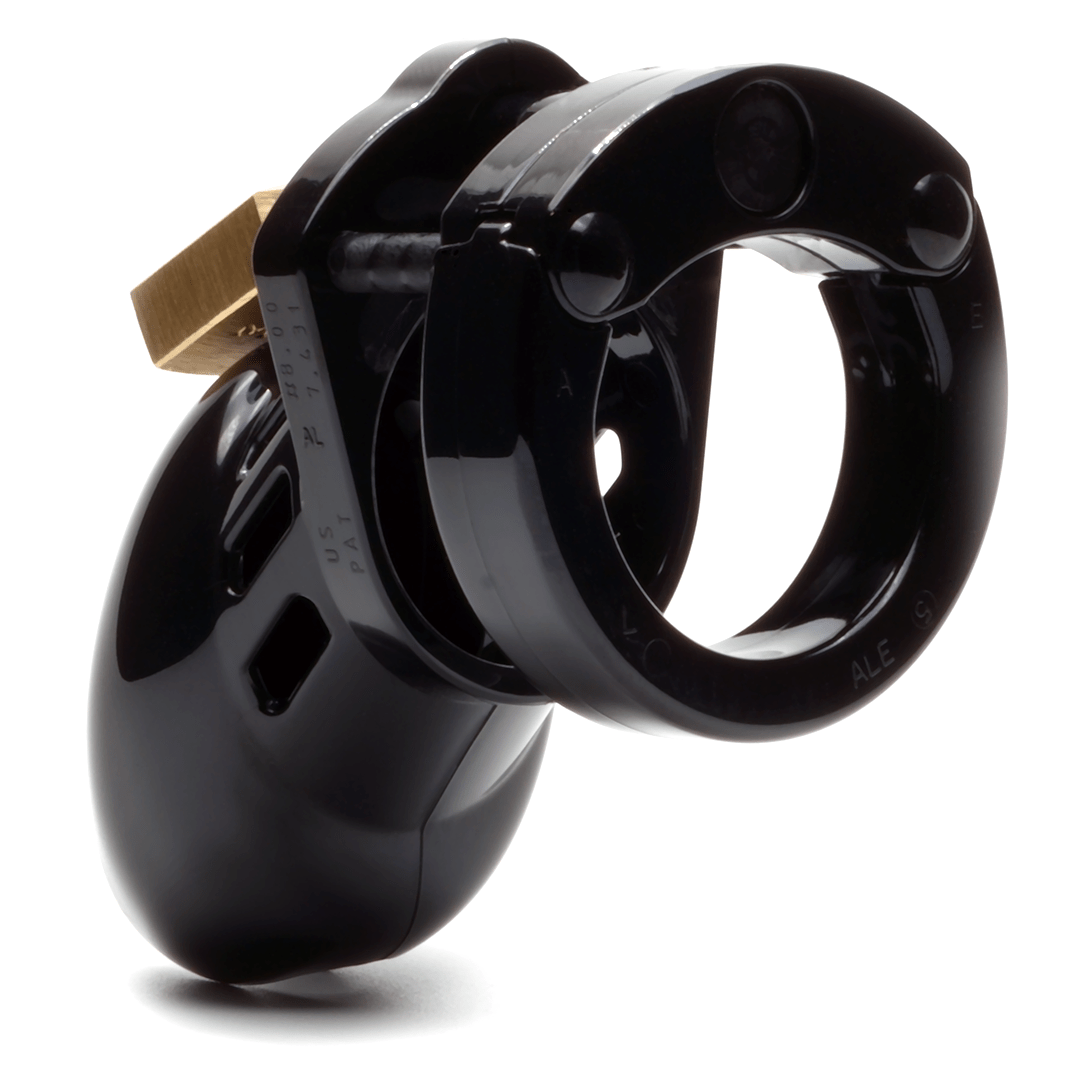 Back and side view, with tip angled to the right of a fully-assembled black CB-6000s penis chastity cage. Three black locking pins connect the base ring to the penis cage and a brass padlock is seen hanging from the center locking pin.