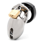 Front view, with tip angled to the left of a fully-assembled chrome finish and black CB-6000s penis chastity cage. Three black locking pins connect the black base ring to the chrome-finish penis cage and a brass padlock is secured through the hole on the center locking pin.