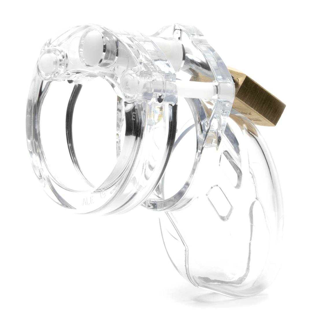 Back and side view, with tip angled to the left of a fully-assembled clear CB-6000s penis chastity cage. Three white locking pins connect the base ring to the penis cage and a brass padlock is seen hanging from the center locking pin.