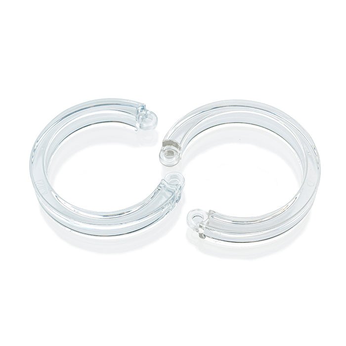 one large and one x-large size clear u-rings laying flat next to each other on white background