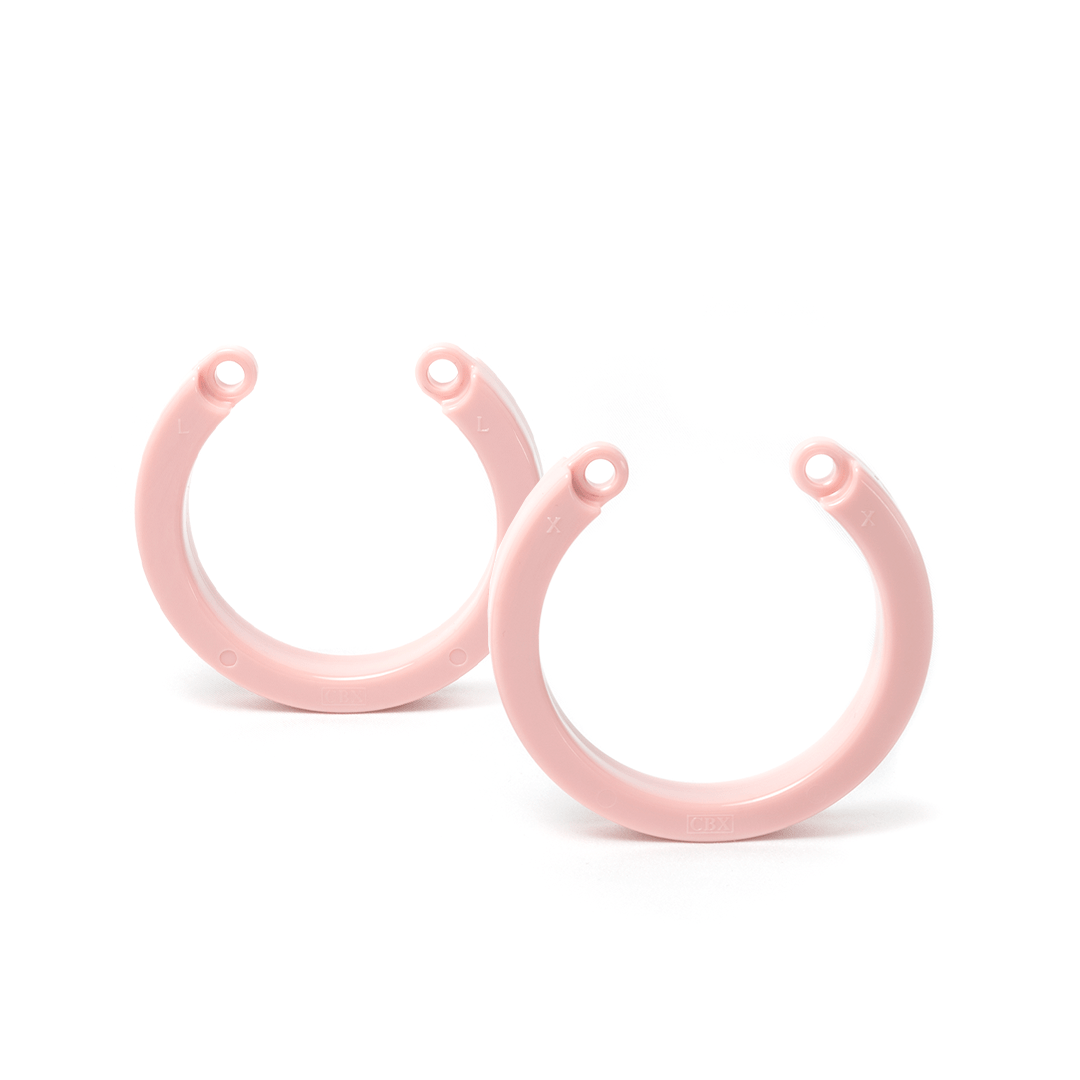 one large and one x-large size pink u-rings next to each other on white background