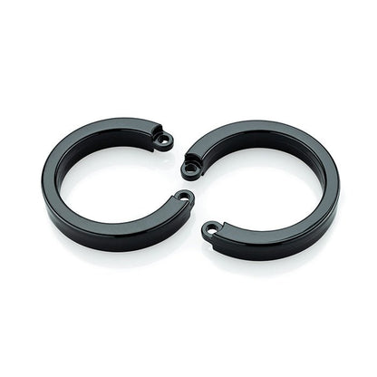 one large and one x-large size black u-rings laying flat next to each other on white background