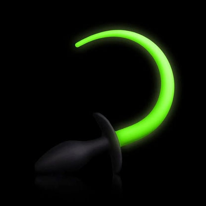 black background black anal butt plug with neon green glow-in-the-dark tail