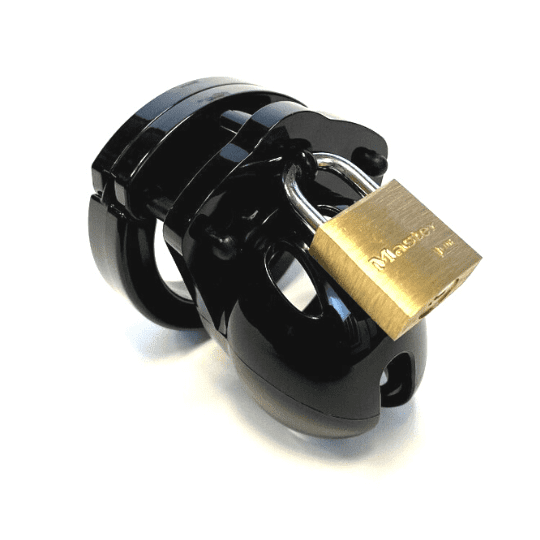 Front view, with tip angled to the right of a fully-assembled black Mini-Me penis chastity cage. Three black locking pins connect the base ring to the penis cage and a brass padlock is secured through the hole on the center locking pin.