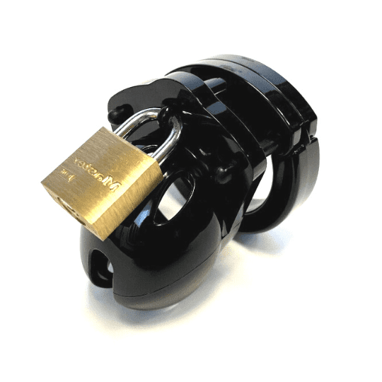Front view, with tip angled to the left, of a fully-assembled black Mini-Me penis chastity cage. Three black locking pins connect the base ring to the penis cage and a brass padlock is secured through the hole on the center locking pin.