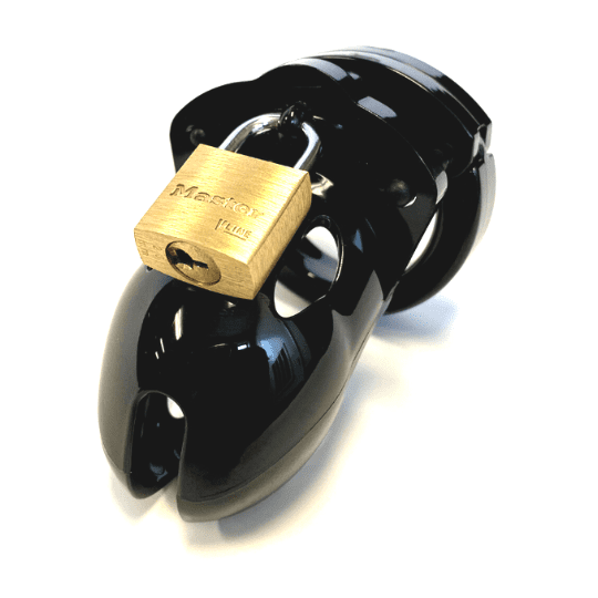 Front view, with tip angled to the left of a fully-assembled black Mr. Stubb penis chastity cage. Three black locking pins connect the base ring to the penis cage and a brass padlock is secured through a hole on the center locking pin.