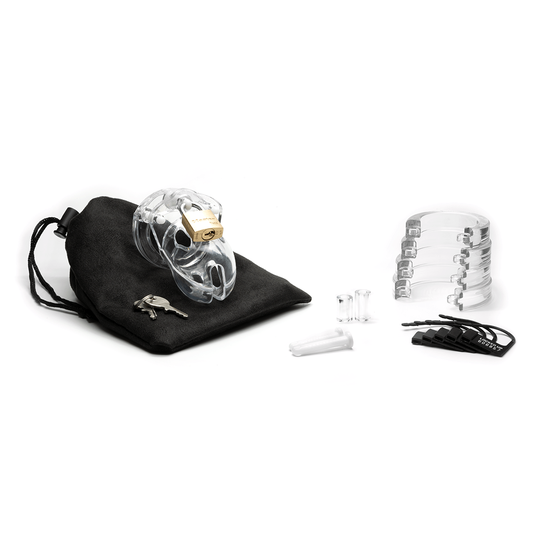 Fully-assembled clear Mr. Stubb chastity cage on black storage pouch with 2 metal keys to left. 2 clear spacers, 2 white locking pins, 4 clear stacked U-rings and 5 black plastic locks sit displayed on right.