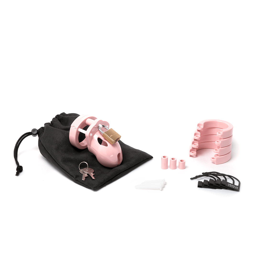 Fully-assembled pale bubblegum pink Mr. Stubb chastity cage on black storage pouch with 2 metal keys to left. 3 pink spacers, 3 white locking pins, 4 pink stacked U-rings and 5 black plastic locks sit displayed on right.